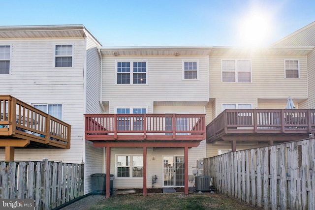 back of property featuring a fenced backyard, central AC, and a wooden deck