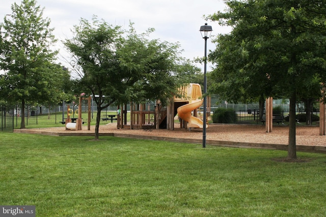 communal playground with a yard and fence