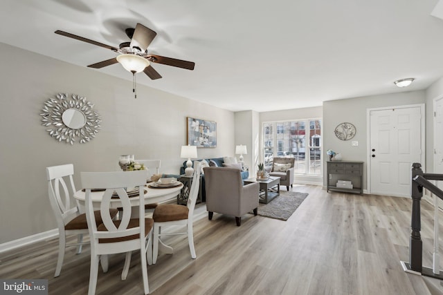 dining room with ceiling fan, baseboards, and wood finished floors