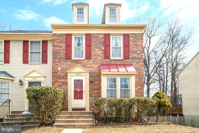 view of front of home featuring entry steps and brick siding