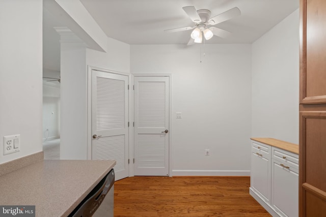 kitchen featuring light wood-type flooring, light countertops, ceiling fan, and baseboards