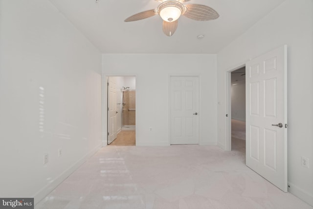 unfurnished bedroom with connected bathroom, baseboards, and ceiling fan