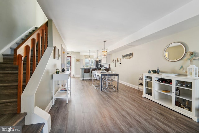 interior space with baseboards, stairway, and wood finished floors