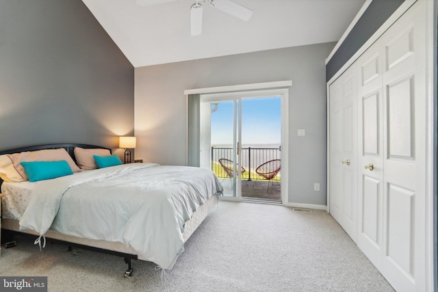 bedroom featuring light carpet, baseboards, lofted ceiling, access to exterior, and a closet