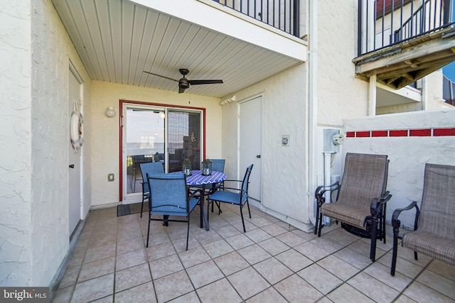 view of patio / terrace featuring a balcony, ceiling fan, and outdoor dining space