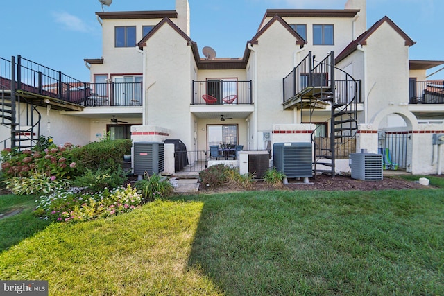 back of house featuring central AC and stucco siding