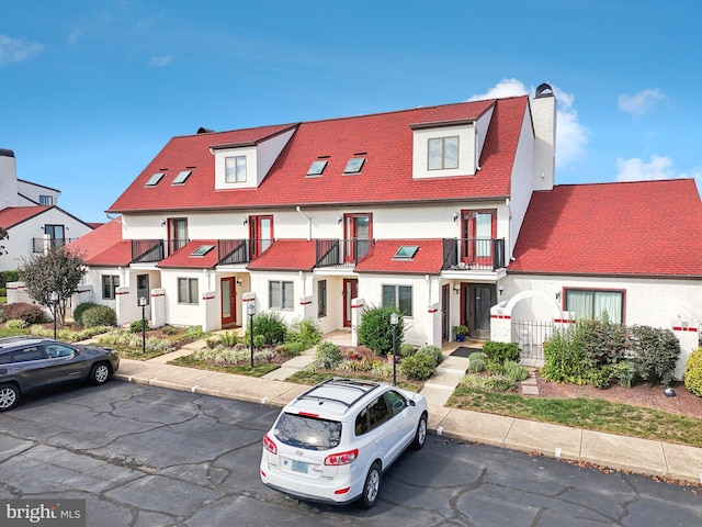 view of property featuring a residential view and a chimney