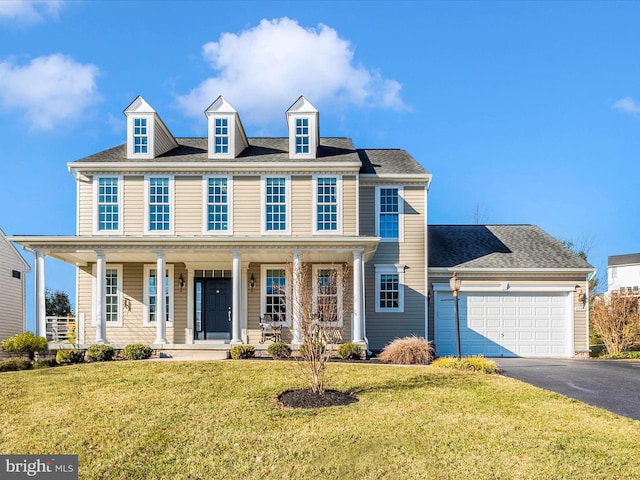 view of front of home featuring a front lawn, aphalt driveway, a porch, an attached garage, and a shingled roof