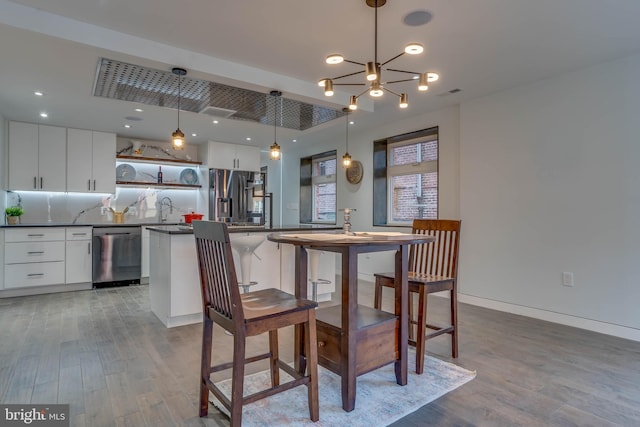 dining area with wood finished floors, visible vents, and recessed lighting