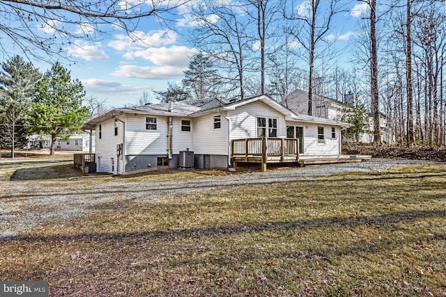 rear view of house featuring a deck, central AC, and a yard