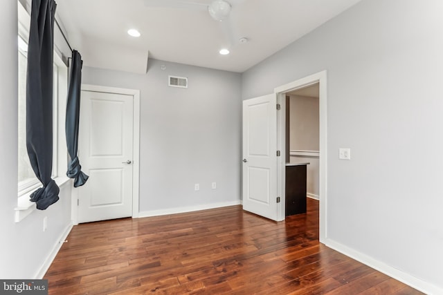 unfurnished bedroom with hardwood / wood-style flooring, baseboards, visible vents, and recessed lighting