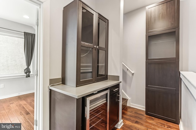 walk in closet featuring wine cooler and dark wood-style flooring