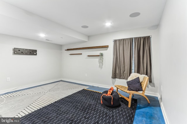 living area featuring baseboards and recessed lighting