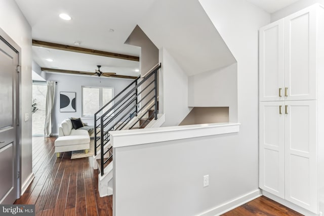 interior space with baseboards, dark wood-style flooring, beamed ceiling, stairs, and recessed lighting