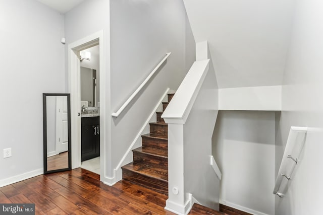 stairway with baseboards and hardwood / wood-style flooring