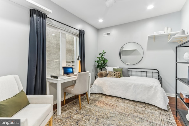 bedroom featuring baseboards, wood finished floors, visible vents, and recessed lighting