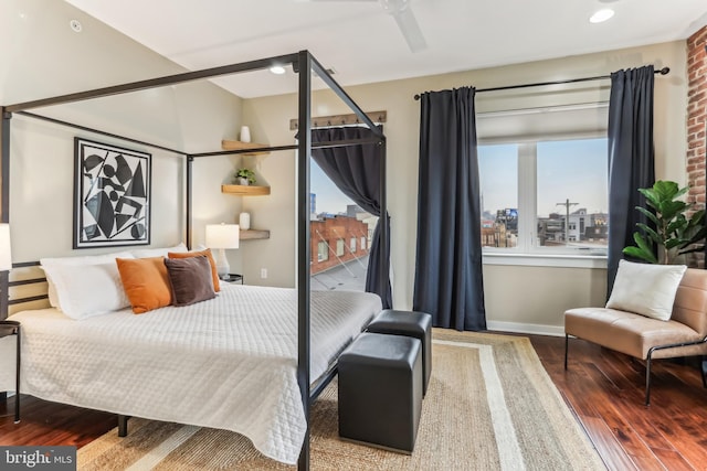 bedroom with recessed lighting, wood finished floors, and baseboards