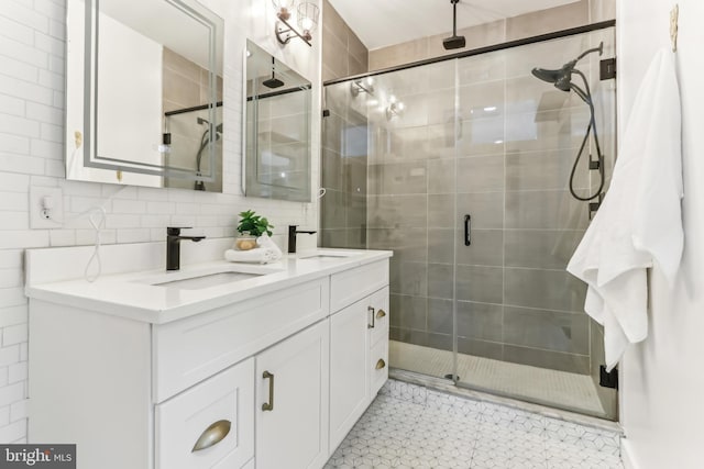 bathroom featuring a stall shower, a sink, and double vanity