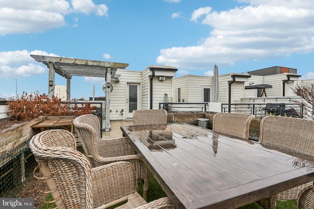 deck featuring outdoor dining space and a pergola