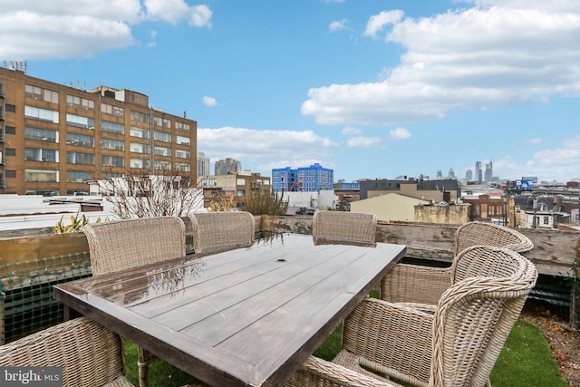 view of patio / terrace with a view of city and outdoor dining area