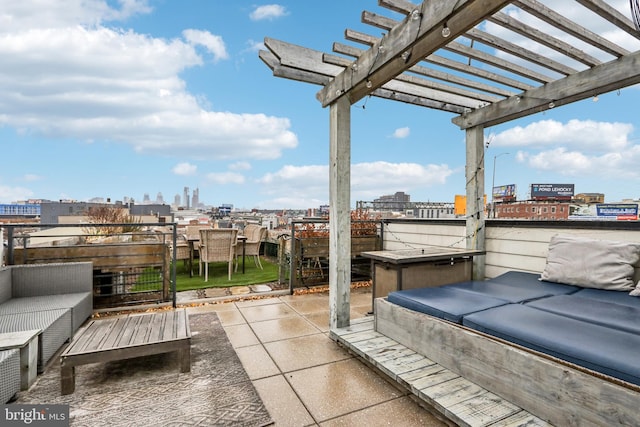 view of patio featuring a pergola, an outdoor kitchen, and a city view