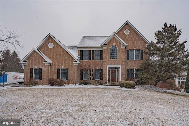 colonial inspired home with brick siding