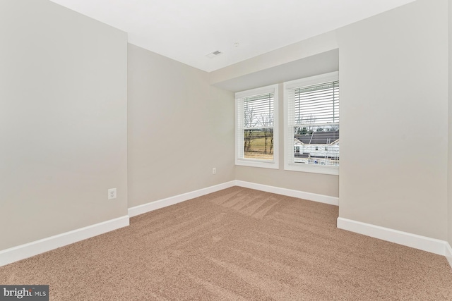 unfurnished room featuring baseboards and carpet flooring