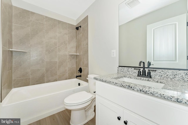 bathroom featuring bathtub / shower combination, visible vents, toilet, vanity, and wood finished floors