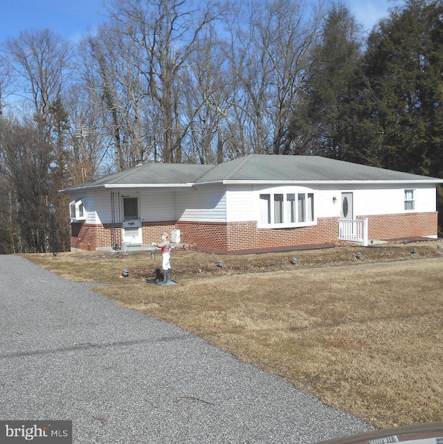 single story home with a front yard and brick siding