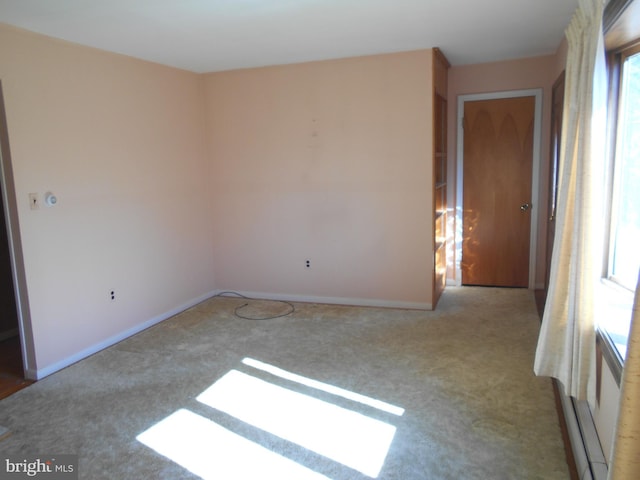 unfurnished room with carpet and baseboards