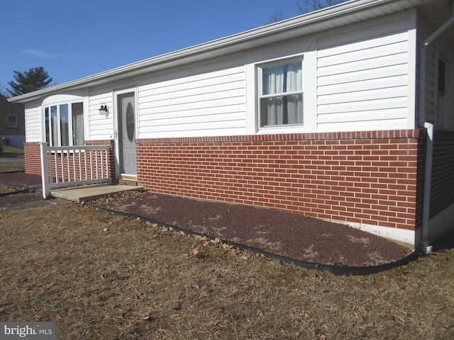 exterior space with brick siding