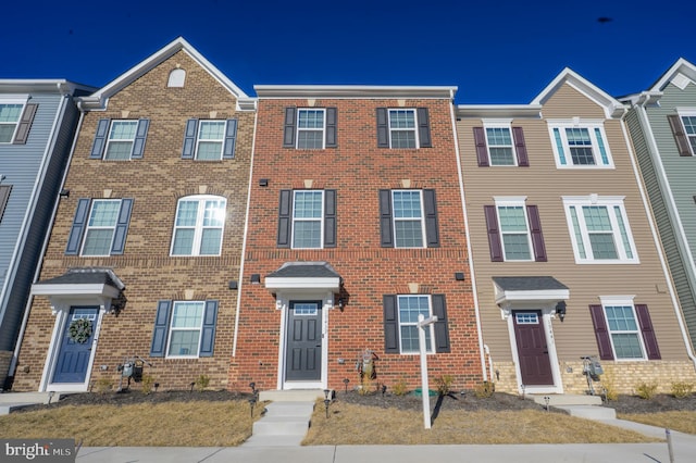 townhome / multi-family property with brick siding