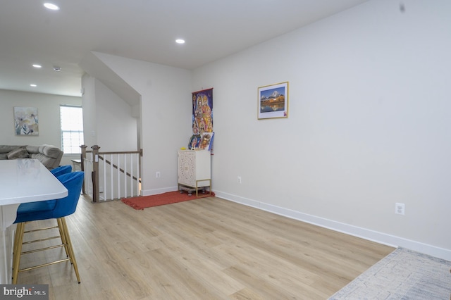 playroom with baseboards, light wood finished floors, and recessed lighting