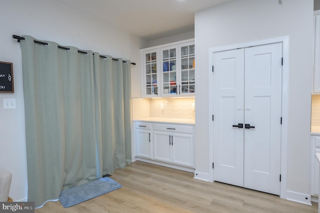 bathroom featuring tasteful backsplash, wood finished floors, and vanity