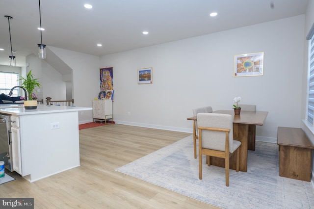 dining room featuring light wood-style floors, baseboards, and recessed lighting