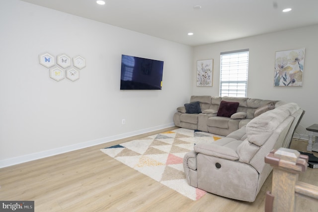 living room with baseboards, recessed lighting, and light wood-style floors