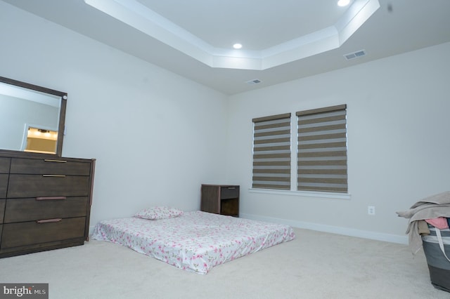 bedroom featuring recessed lighting, light colored carpet, visible vents, baseboards, and a tray ceiling