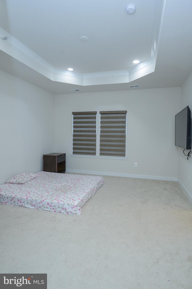 carpeted bedroom featuring a raised ceiling, visible vents, and recessed lighting