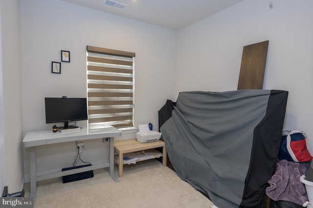 home office featuring light carpet, visible vents, and baseboards