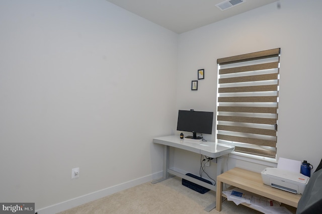 home office featuring baseboards, visible vents, and light colored carpet