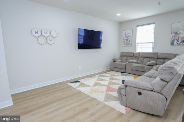 living room with light wood-type flooring, baseboards, and recessed lighting