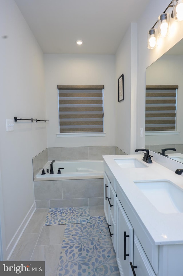 full bathroom with tile patterned floors, a garden tub, a sink, and double vanity