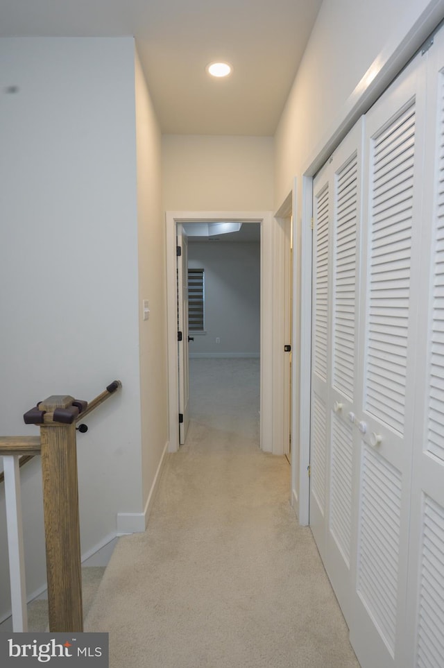 corridor with recessed lighting, light carpet, and baseboards