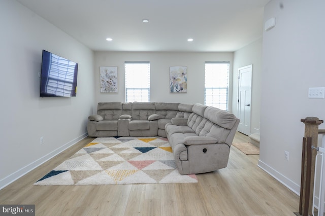 living room with recessed lighting, baseboards, and light wood finished floors