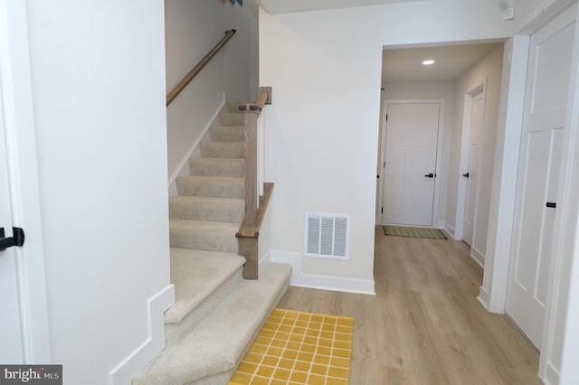 stairs featuring recessed lighting, wood finished floors, visible vents, and baseboards