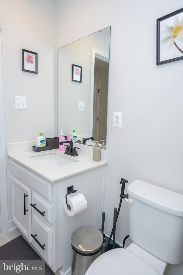 bathroom with toilet and vanity