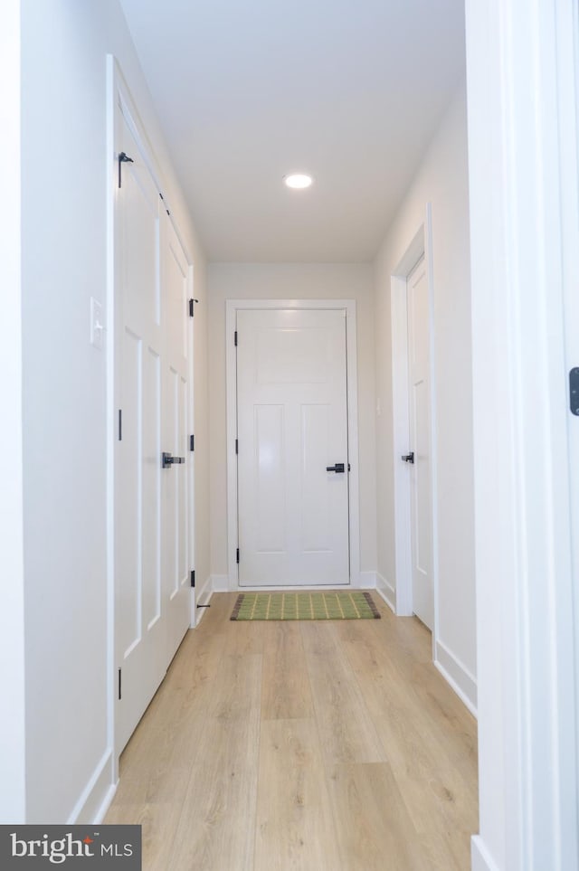 corridor with recessed lighting, baseboards, and light wood finished floors