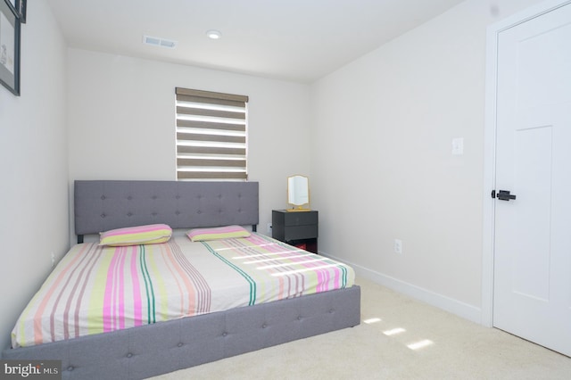 carpeted bedroom with visible vents and baseboards