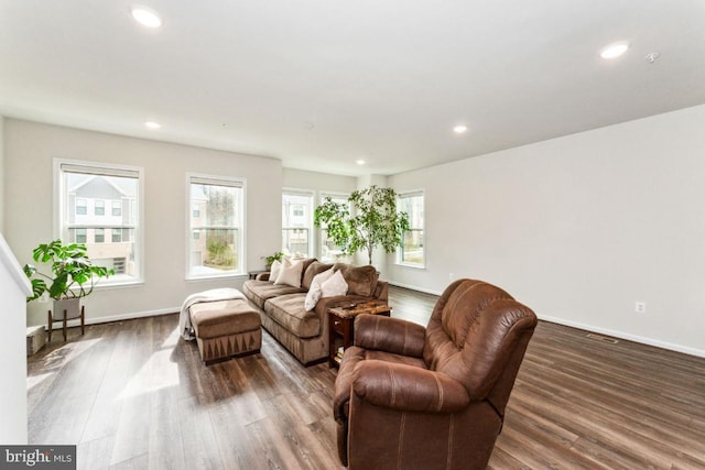 living room with recessed lighting, baseboards, and wood finished floors