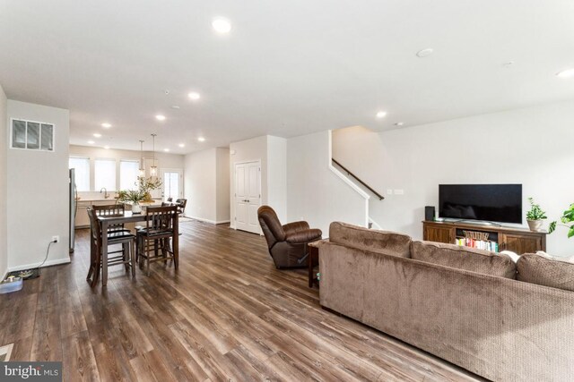 living room with dark wood-style floors, baseboards, visible vents, and recessed lighting